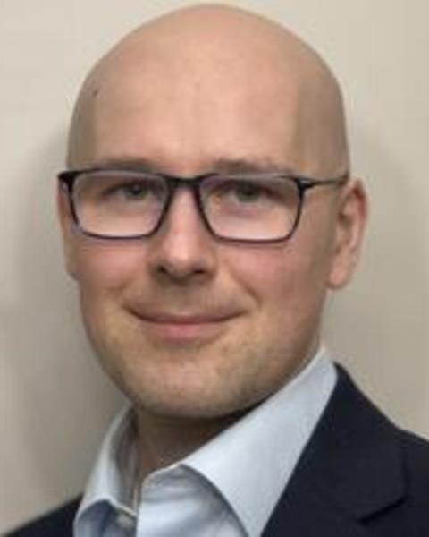 Professional headshot of a person wearing glasses