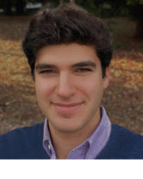 headshot of a man standing outside