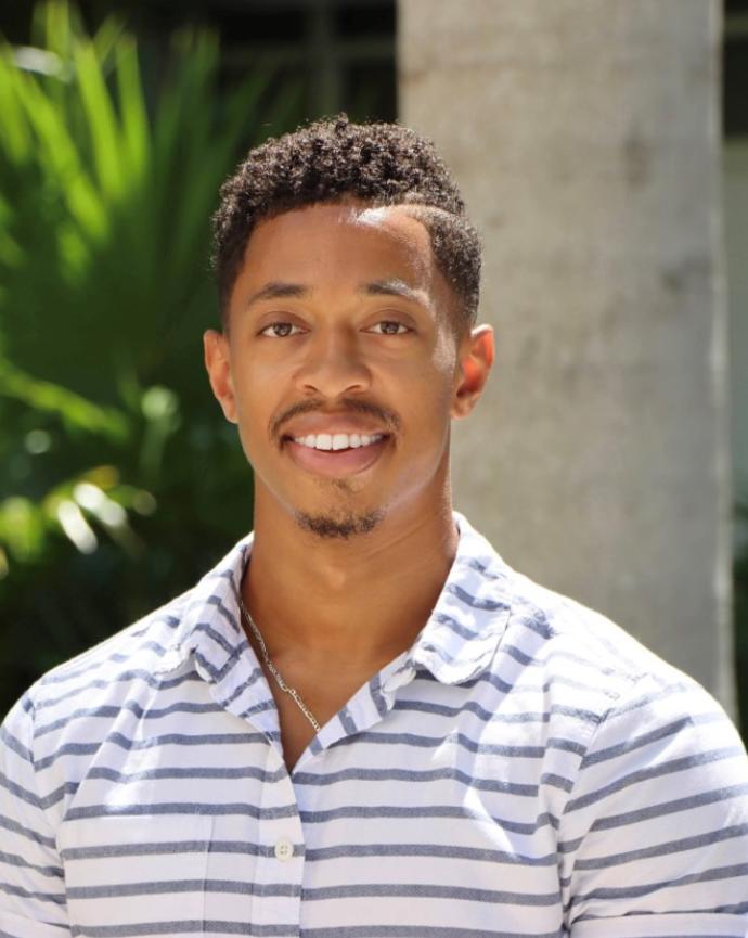 A person smiling standing outside
