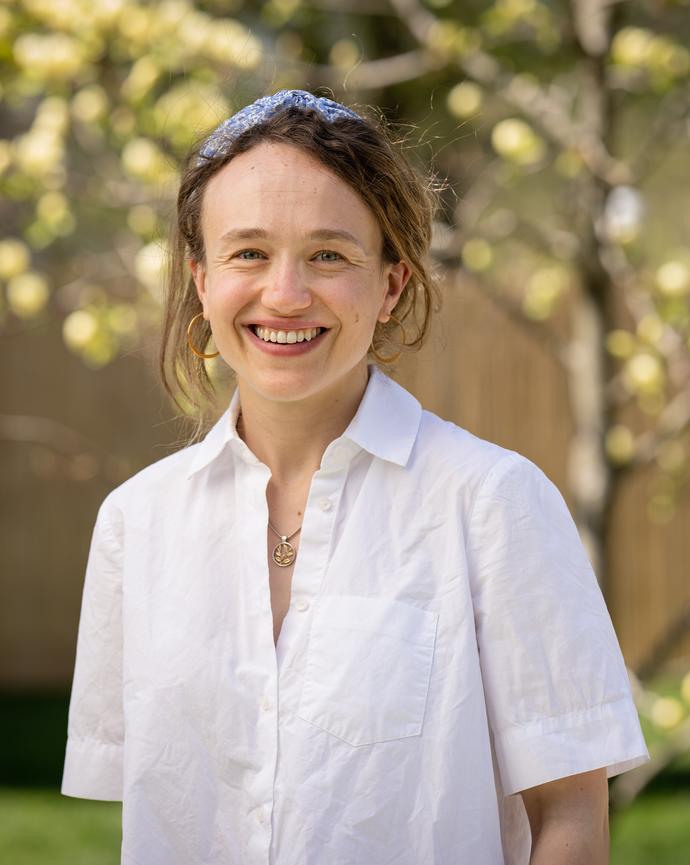 A photo of a brown haired woman wearing a white shirt